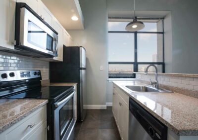 Galley apartment kitchen with stainless steel appliances at The Pepper Building in Philadelphia